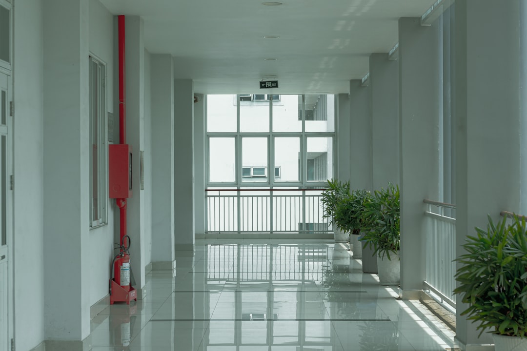 Perhitungan Teknik Smoke - red fire extinguisher on white wall