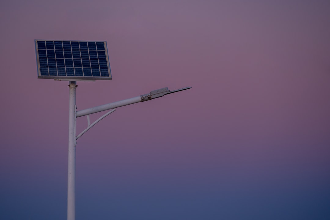 PJU Hybrid PLTS - Solar panel street lamp against a twilight sky