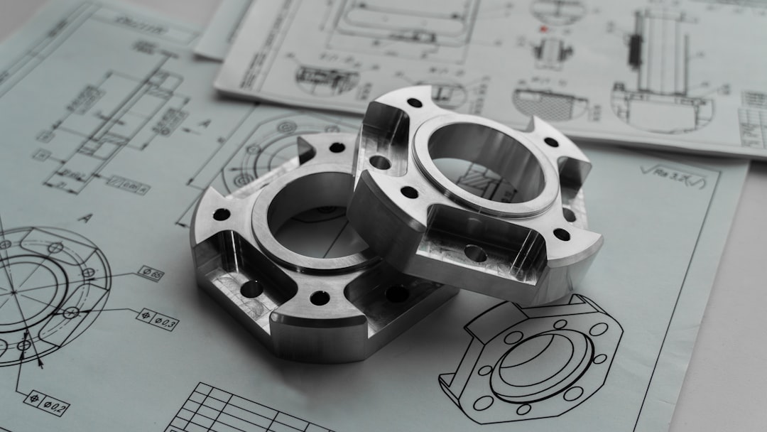 Gambar PID Sistem - Two metal mechanical parts on engineering blueprints