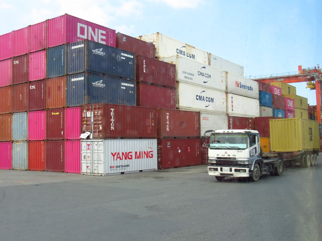 Stacked shipping containers with a truck moving