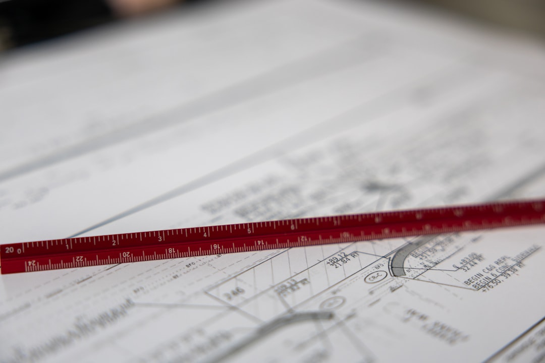 A ruler sits on blueprints.