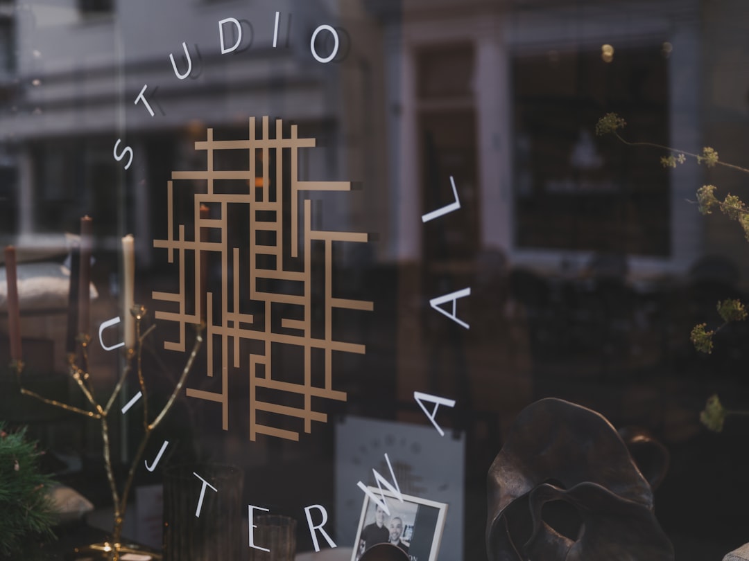 Studio logo on glass storefront with reflections
