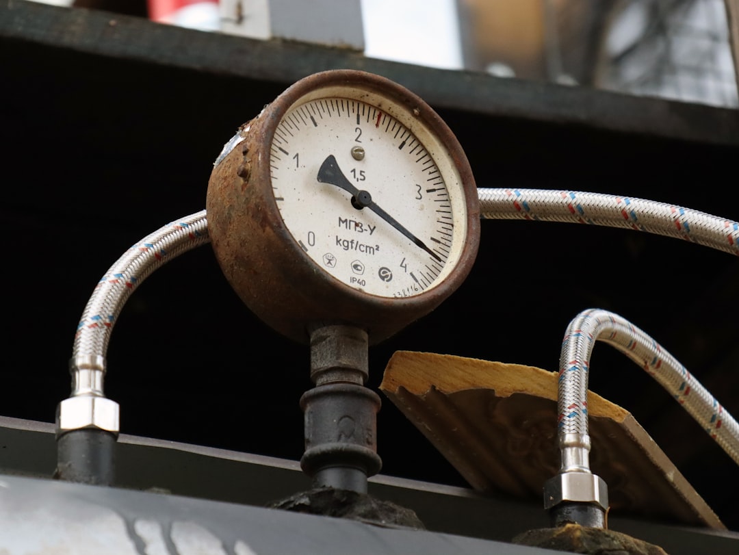 a close up of a pressure gauge attached to a pipe