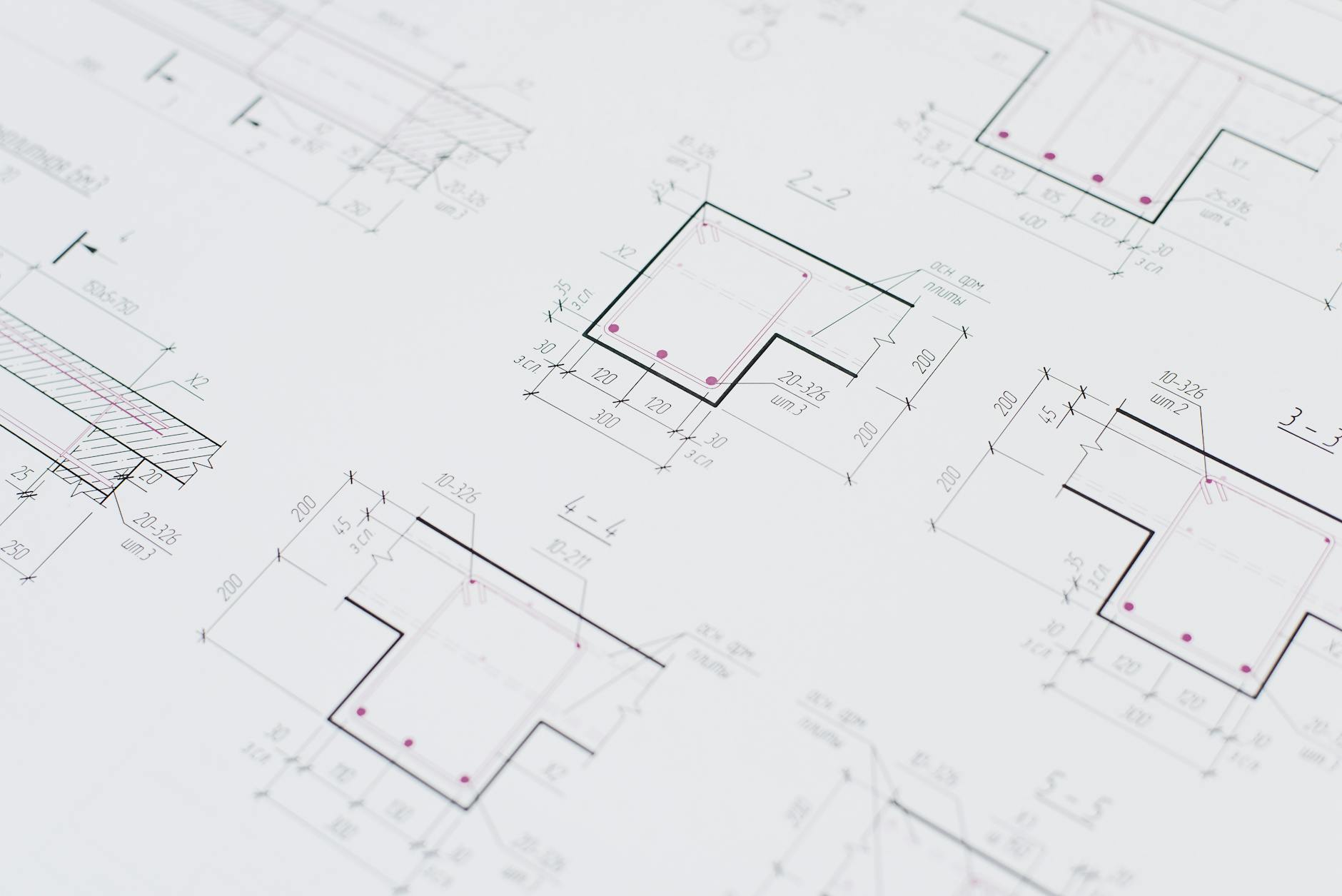 High-resolution close-up of detailed architectural blueprints showcasing precision design layouts.