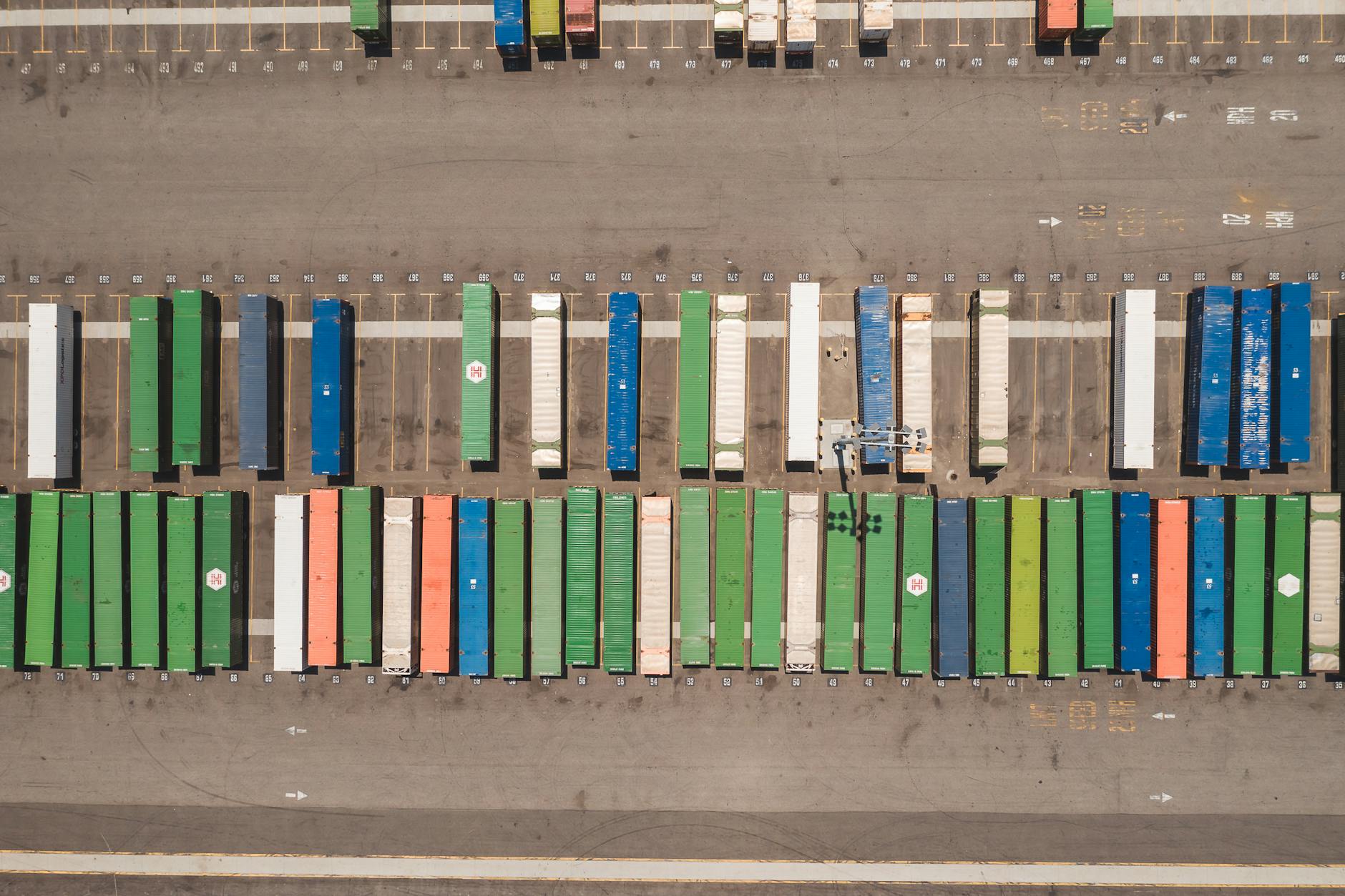 Top view of neatly arranged cargo containers in a shipping port, highlighting logistics and global trade.